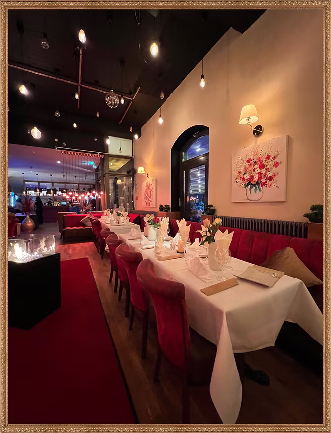 Festively laid long table with red velvet chairs and roses at Matzbach restaurant in the Marheinekehalle, Berlin-Kreuzberg